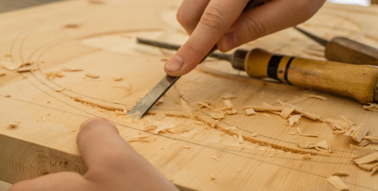 A chisel shaping wood by hand